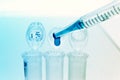 Pipette adding fluid to one of several test tubes .medical glassware Royalty Free Stock Photo