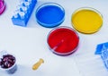Pipette with drop of color liquid and petri dishes Royalty Free Stock Photo