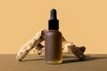 Pipette oil bottle, wooden driftwood. Monochrome brown mockup, poster, banner. Beauty frosted vial with herbal extract,
