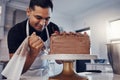 Piping, bakery and chef baking a cake with chocolate and pastry in a kitchen and is happy decorating his recipe. Food Royalty Free Stock Photo