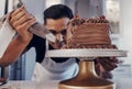 Piping, chef and man baker baking a cake with chocolate in a kitchen or pastry cook preparing a sweet recipe. Food Royalty Free Stock Photo