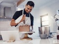 Piping, decorating and man baking a cake with chocolate in a kitchen or pastry chef happy with online recipe. Food Royalty Free Stock Photo