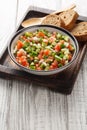 Pipirrana typical Malaga Spanish salad with onion, tomato, green pepper and cucumber closeup on the plate. Vertical