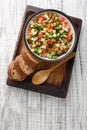 Pipirrana typical Malaga Spanish salad with onion, tomato, green pepper and cucumber closeup on the plate. Vertical top view