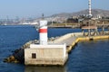 Piraeus lighthouse with a red stripe to navigate ships that enter the port of Athens
