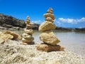 Piramide stack of zen stones near sea and blue sky Royalty Free Stock Photo