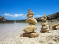 Piramide stack of zen stones near sea and blue sky Royalty Free Stock Photo