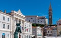 Piran - Artistic statue of man set against picturesque backdrop of Tartini Square in enchanting coastal town