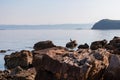 Piran - Cormorant bird on rock with panoramic view of idyllic coastline of Gulf of Piran Royalty Free Stock Photo