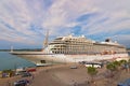 View of moored huge luxury cruise ship against blue sky. Selective focus with wide angle lens