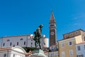 Piran - Statue of renowned violinist Giuseppe Tartini set against picturesque backdrop of Tartini Square