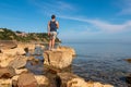 Piran - Tourist man standing on rock with scenic view of idyllic coastline of Gulf of Piran Royalty Free Stock Photo