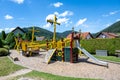 Pirate boat as play equipment on playground. Colorful wooden pirate boat With slide, climbing frame and suspension bridge