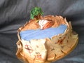 Pirate cake fondant with ship, palm, sand and map of gold riches Royalty Free Stock Photo