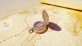 Pirate compass on the Treasure Map lying on the sand on the island of pirates. Vintage beautiful pirate compass lying on Royalty Free Stock Photo