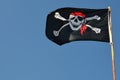 Pirate flag against blue sky, copy space Royalty Free Stock Photo
