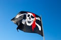Pirate flag flies against the blue sky Royalty Free Stock Photo