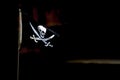 Pirate flag flying on a black background Royalty Free Stock Photo