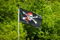 A pirate flag on a white pole Royalty Free Stock Photo