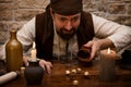Pirate is gambling with dice on a medieval table, concept luck a Royalty Free Stock Photo