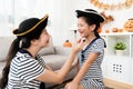 Pirate girl and mother makeup drawing scars Royalty Free Stock Photo