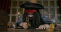 Pirate looks through loupe on map searching for treasures