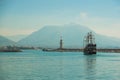 Pirate ship for the entertainment of tourists sailing on the sea. Lighthouse on a background of mountains. Alanya, Antalya Royalty Free Stock Photo