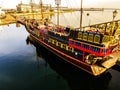 The pirate ship is moored in the port. Wooden ship afloat. Royalty Free Stock Photo