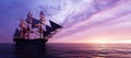 Pirate ship sailing on the ocean at sunset Royalty Free Stock Photo