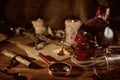 Pirate still life with candle, compass, dark rum in a skull bottle and old papers