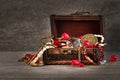 Pirate treasure background, gems, gold, pearls, coins and jewelry in an old wooden chest with an open lid, vintage key, concept of Royalty Free Stock Photo