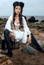 Pirate woman sitting near treasure chest