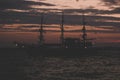 Pirates concept of soft focus old vintage ship silhouette on sea water surface in romantic lighting twilight evening time after Royalty Free Stock Photo