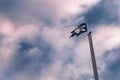 Pirates flag on mast against dramatic cloudy sky Royalty Free Stock Photo