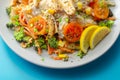 Piri piri style chicken on a bed of wholewheat pasta and vegetables, with a cool sour cream and chive dressing