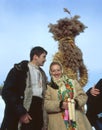 Couple near straw scarecrow