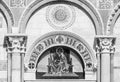 Black and white photo in close-up showing religious mosaic decorating the exterior facade of catholic Basilica in Pisa