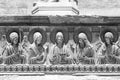 Black and white photo showing in close-up sculptures of angels, saints and Jesus carved in a marble wall