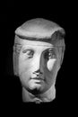 Black and white photo of stone statue head representing a young man Royalty Free Stock Photo