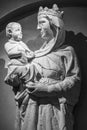 Black and white photo in close-up on stone statues of young Virgin Mary holding baby Jesus Royalty Free Stock Photo