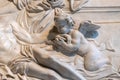 Close-up on statue of angel kissing dead JesusÃÂ´ s hand carved in a marble wall Royalty Free Stock Photo