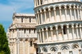 Exterior facade of leaning tower and catholic Basilica in Pisa