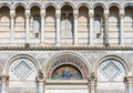 Close-up on arches and colorful fresco decorating the exterior facade of Basilica in Pisa