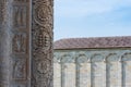 Close-up on sculptures carved in marble column decorating the exterior facade of catholic church in Pisa Royalty Free Stock Photo