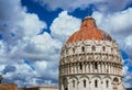 Pisa Baptistry dome with clouds and walls