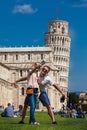 Young couple of tourists taking a selfie in front of the famous Leaning Tower of Pisa Royalty Free Stock Photo