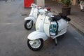 two white vespa motorcycles/scooter in the streets of Pisa, Tuscany