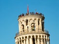 The top of the Leaning Tower with tourists, Pisa, Italy