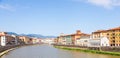 Pisa, Italy - colourful buildings on Arno river. Urban skyline, travel destination