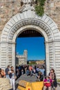 Pisa, Italy - 25 June 2018: The leaning tower of pisa viewed through entrace arch of Piazza dei Miracoli